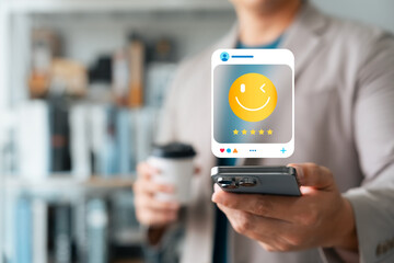 Man holding smartphone with digital smiley face and five-star rating, representing customer satisfaction, social media feedback, and positive online reviews in modern digital marketing.
