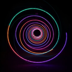 Abstract spiral light tunnel of concentric circles in various vibrant colors. Colorful LED light display in a dark outdoor setting.