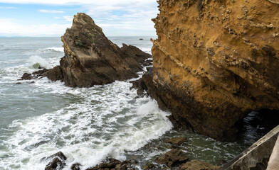 Coastal rocks and yellow cliff at the Atlantic shore
