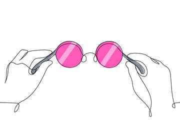 Human hands holding round pink glasses close-up - one line art vector. concept of looking at the world through rose-colored glasses, life in pink