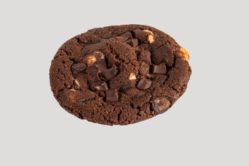 A large chocolate cookie topped with chocolate chips, set against a white background.