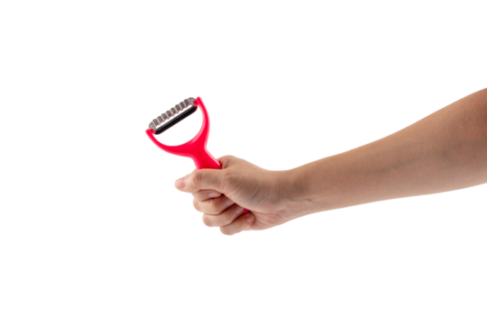 Pink fruit peeler and hand on transparent background
