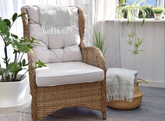 Wicker rattan chair with green indoor plant on the terrace.Relaxation area.