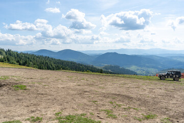 Mountains ranges in the Carpathians. Hills, forest and meadows. Green valley. Village Ukraine