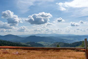Blue clouds sky. Mountains ranges in the Carpathians. Hills, forest and meadows. Green valley Ukraine