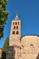 Fototapeta premium A low angle perspective highlights the architectural details of the medieval San Andres Church tower and apse in Segovia, a popular Spanish tourist destination.