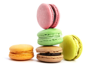 Pile of macaron cookies in various flavours and colours isolated on white background.