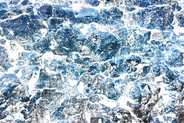 Distressed Grungy Blue Overlay Dry Coral Rock Wall Texture from Tropical Coastline with Natural Holes