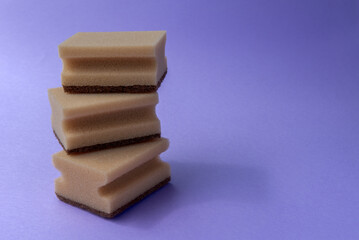 three dish sponges on the violet background