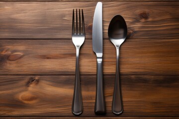 Dining essentials fork knife and spoon arrangement on wooden table close-up culinary concepts
