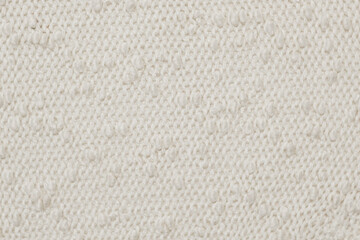 Soft Knitted Woolen Detailed Texture. Natural Fabric Closeup Knit Pattern. Beige Knitwear, Warm Cashmere Surface. Rotation, Macro. Cozy Creamy Textile Background. Clothes Production. Melange Yarn. 4K