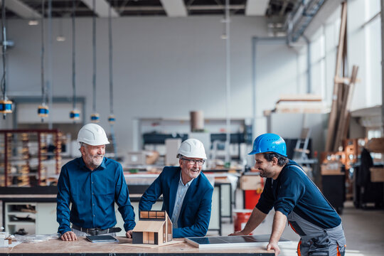 Engineers and craftsmen collaborating in an industrial workspace