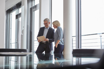 Businessman and businesswoman collaborating in a modern office
