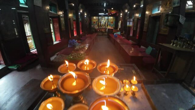 Clay Lamps Illuminating the Sacred Interior of Hiranya Varna Mahavihar, ( Golden Temple ) Kathmandu, Nepal 