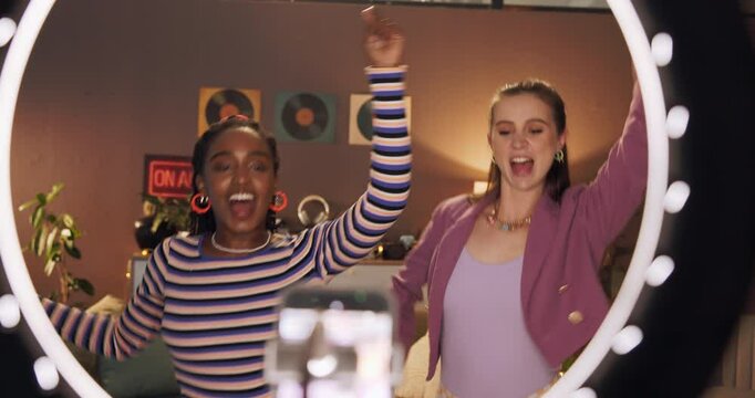 Happy, ring light and girls in bedroom dance for social media, recording and post on internet. Influencer, content creator and friends with energy for performance, viral video and online tutorial
