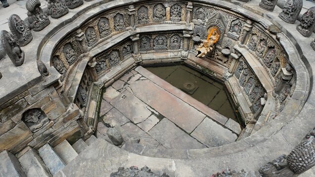 Ancient Stone Fountain with Carved Deities in Historic Patan Courtyard, Kathmandu Nepal