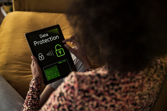 Woman accessing data on digital tablet at home
