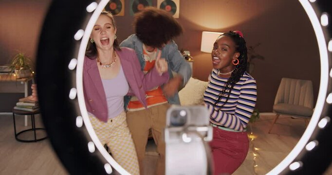 Happy, ring light and friends in home dance for social media, recording and post on internet. Influencer, content creator and people with energy for performance, viral video and online tutorial