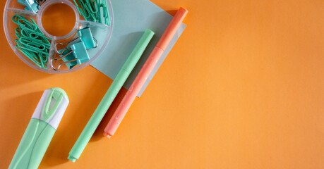  Minimalist Flat Lay of Student Supplies on Soft colors arranged on a vibrant background.