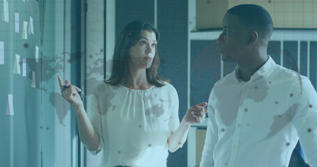 Image of world map and globe over diverse business people