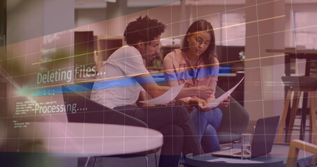 Image of deleting files over diverse female and male coworkers in office