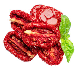 Halves of sun-dried plum tomatoes and fresh basil leaves on white background. File contains clipping path.