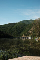 Hydroelectric dam with lush mountains reflected in the river. Zapadna Morava lake in Serbia country.