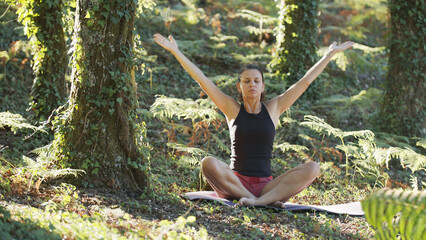 Woman is practicing yoga in nature.