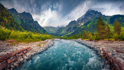 Stunning summer view of azure mountain river in Caucasus mountains. Majestic outdoor scene of Upper Svaneti, Georgia, Europe. Beauty of nature concept background..