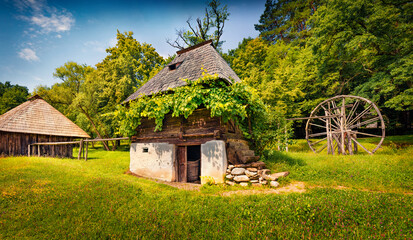 Sunny summer view of traditional romanian wooden peasant houses. Wonderful rural scene of Transylvania, Romania, Europe. Beauty of countryside concept background..