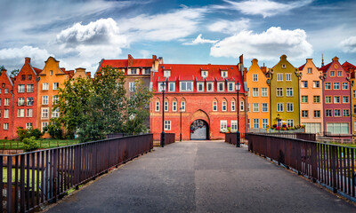 Attractive morning cityscape of Gdansk town with old colorful buildings, Poland, Europe. Colorful summer scene of Cow Bridge to old town. Traveling concept background.