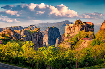 Sunny morning view of famous Eastern Orthodox monasteries listed as a World Heritage site, built on top of rock. Attractive summer scene of Kalabaka location, Greece. Traveling concept background.