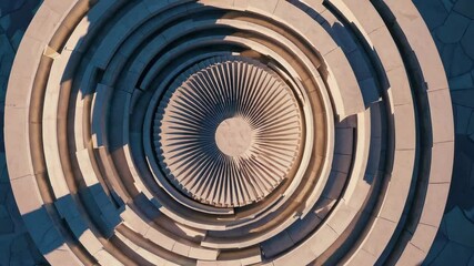 Aerial animation of circular abstract architectural structure with layered radial symmetry and central sunlight, evoking futuristic design and modern urban geometry aesthetics - Powered by Adobe