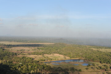Beautiful natural green landscape from Mihintale mountain peak near Anuradhapura city in Sri Lanka in the afternoon with blue sky