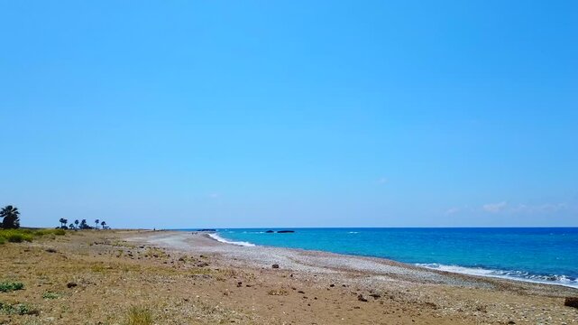 Gentle morning waves move across the shore at Mandria Beach, Cyprus. Soft light, peaceful water, and natural beauty&mdash;perfect for relaxation, travel, coastal, or mindfulness-themed footage.