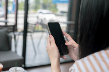 Close-up view of smartphone on hands of female in cafe on holiday. Concept for business contact interpersonal communication technology device.