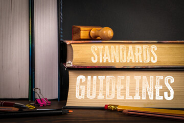 Standards and Guidelines. Books with Stamp and Office Supplies on Desk