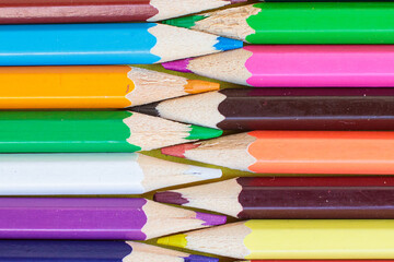 Colored pencils on a yellow background. Bright juicy background for inscriptions. Summer background. School. September 1. Office. Study.