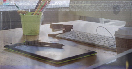 Image of desk over group of business people walking