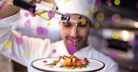 Image of falling yellow and purple dots over cook