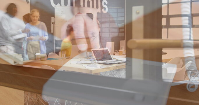 Image of person using computer over group of business people