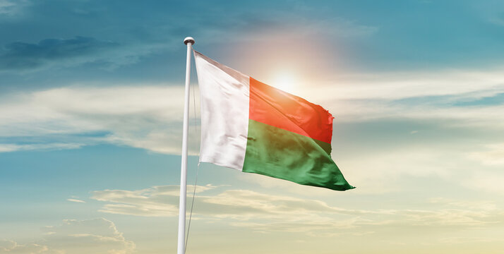 Madagascar national flag waving in beautiful sky with mast. A proud moment flag waving with sunlight.