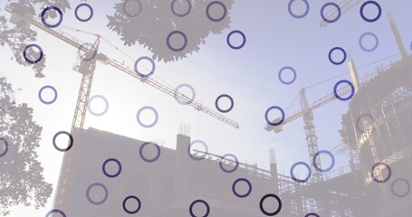 Image of falling circles over construction site