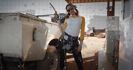 Image of world map and globe over women refueling