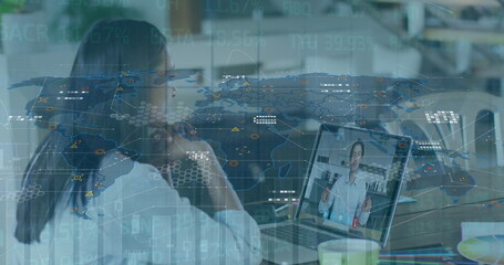 Image of graphs and world map over woman having image call on laptop