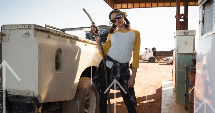 Image of arrows over women refueling car