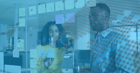 Image of financial data processing and globe over diverse business people in office