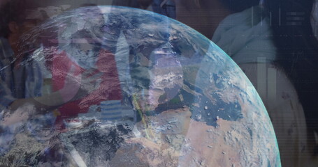 Image of globe rotating over diverse businesspeople in office