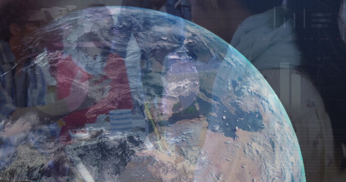 Image of globe rotating over diverse businesspeople in office - Powered by Adobe