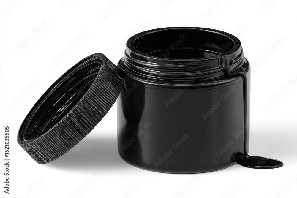 Aufkleber Black paint jar with a partially open lid spilling paint in a studio setting during daylight hours